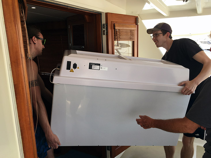 Ryan Schlaiss (Eckerd College) and Travis Mellet (USFCMS) load a trace metal clean chemistry hood onto the R/V Angari.