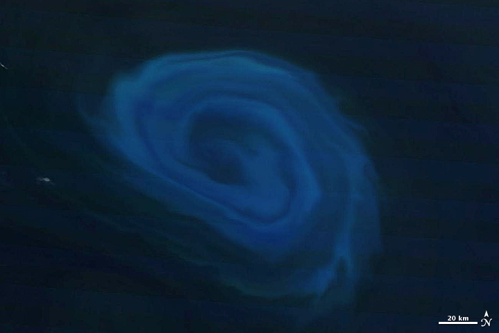 A deep-ocean eddy captured by NASA’s Terra satellite on December 26, 2011. This natural-colored image shows plankton blooming (light blue) and swirling in this open ocean storm. 