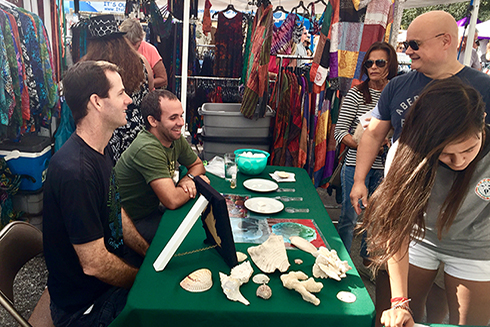 Sean Beckwith and Luis Sorinas discuss the impact of ocean acidification on calcifying organisms with members of the St. Pete community. 