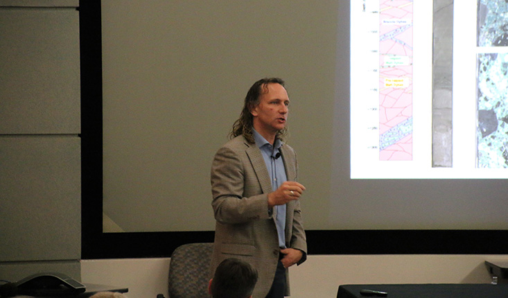 Sean Gulick, Ph.D., describes to the audience the rock content found in the drill cores of the Chicxulub crater. 