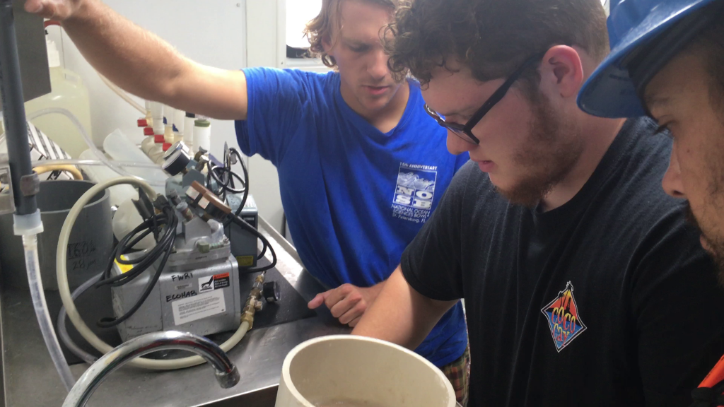 Sebastian DiGeronimo’s main task on the noon to midnight shift was to serve as data recorder. Here he washes the organic matter, including the unseen fish eggs, over a sieve to concentrate the material before adding it to the collection jar. Garrett Miller and Ian Williams look on, ready to assist.