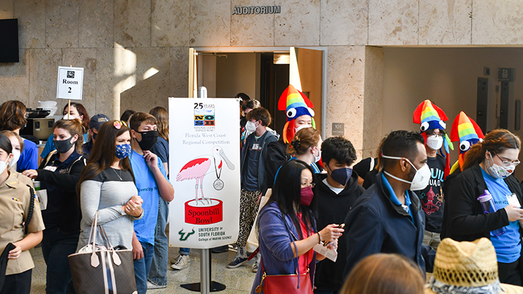 Participants, volunteers, and audience members exit the auditorium between competition.