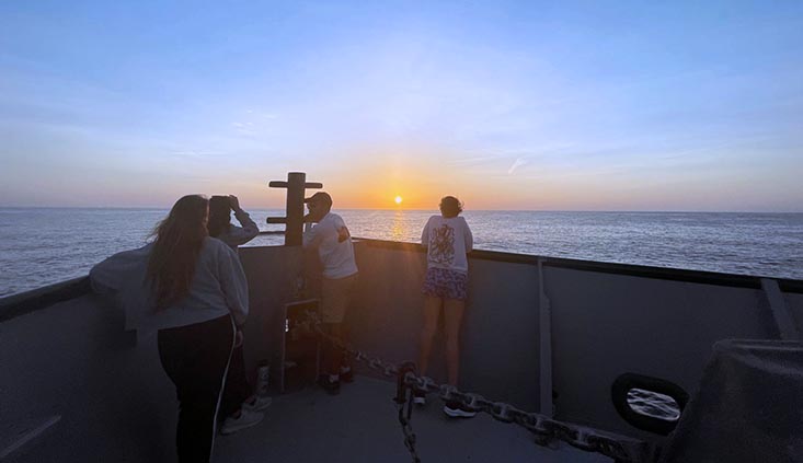 Students take in a sunset on one of the final days of the cruise in the Gulf of Mexico. Photo credit: Carlyn Scott