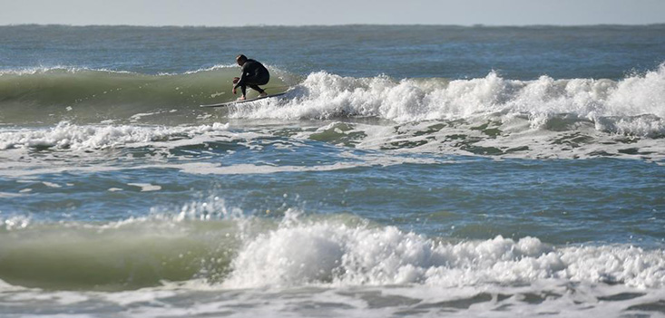 A surfer on Siesta Beach takes advantage of swells created by a storm front that brought windy weather over the weekend. Morning temperatures dipped into the low 40s across the area. Photo Credit: Herald-Tribune staff photo / Mike Lang 