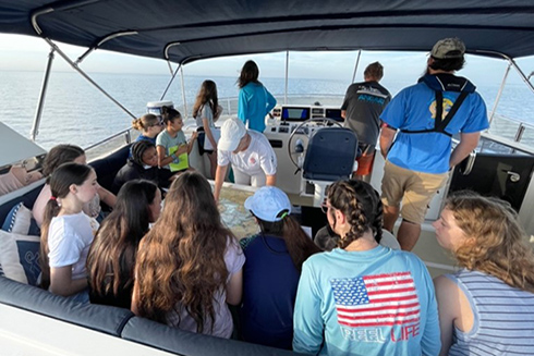 Teresa Greely orients the campers to where the day’s activities will take place in Tampa Bay as the R/V Angari gets underway.