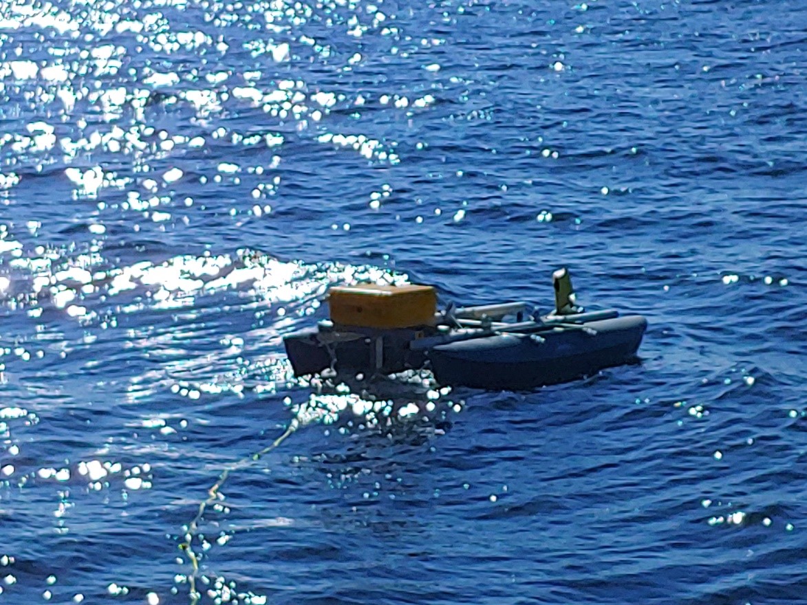 Deployed and connected to the R/V Hogarth by a tether line, the calibration float holds the glider partially submerged while the EKMini echosounder is calibrated.