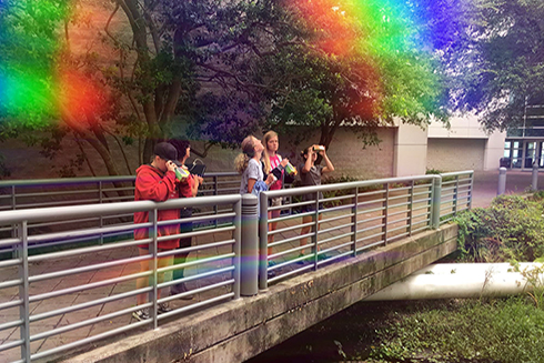 The rainbow “filter” for the photo was made using the eye piece of the spectroscope the girls made during the lab.