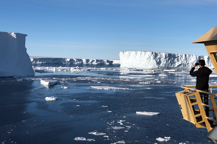 Ali Graham, PhD, a geophysicist at the USF College of Marine Science observes the Thwaites Glacier in Antarctica from the R/V Nathanial B. Palmer.