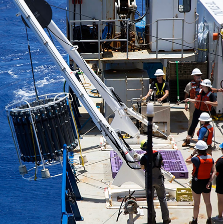 The trace metal CTD rosette gets hauled back on board during the GP15 cruise in the Pacific Ocean. Credit: Alex Fox