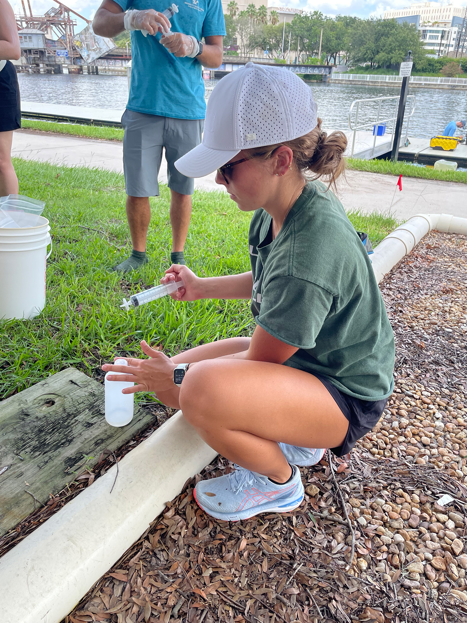 Graduate student Hannah Hunt (USF) filters Hillsborough River water via syringe. The USF team will analyze the water samples for dissolved trace elements. Credit: Tim Conway, USF