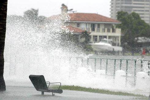 Waves from hurricane Rita crash over a seawall and flood a street 20 September 2005, in Miami, Florida.  Photo credit should read ROBERT SULLIVAN/AFP via Getty Images