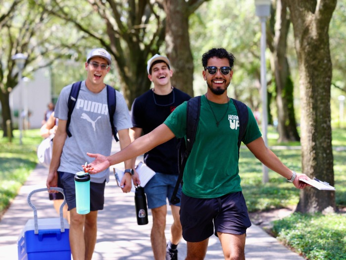 Three students walking outside on campus