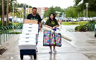 Students and parents walk on campus during move-in day