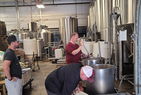Men work inside a brewery