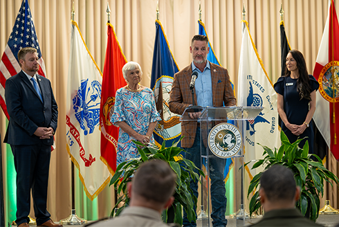 Group stands at a podium during news conference