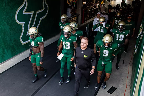 USF football team walks through breezeway