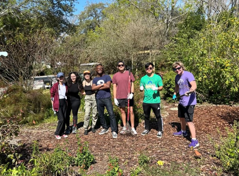 thomas and a group pose in botanical garden