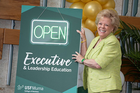 President Rhea Law stands in front of sign that reads,