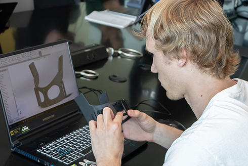 USF student examines medical device