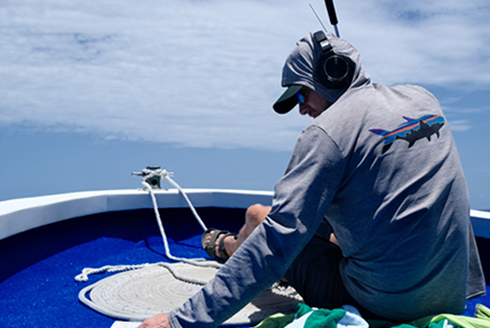 USF Integrative Biology Professor Lucas Griffin sits on a boat