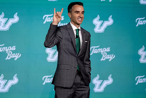 Rob Higgins gives the Go Bulls hand signal on stage
