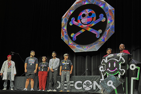 Competitors stand on stage at DEF CON