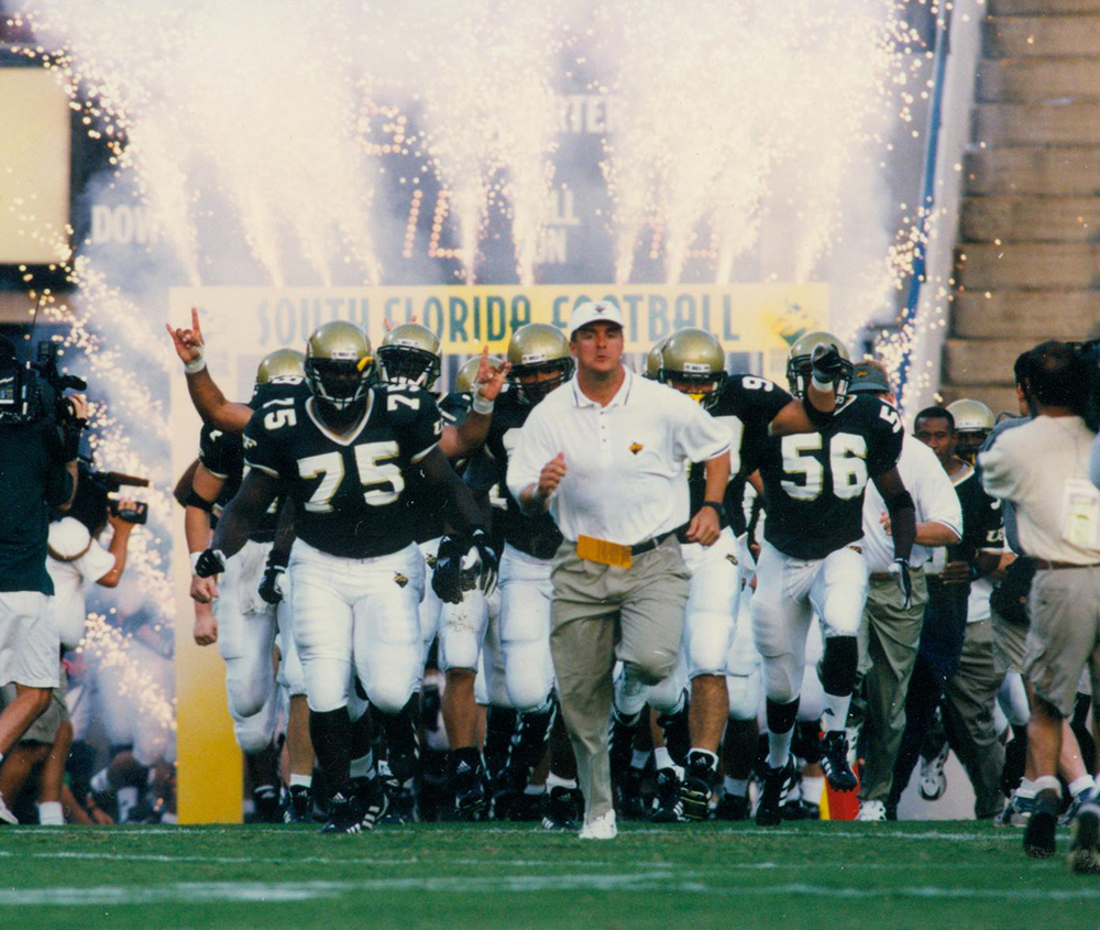 Football team rushes the field in the 1980s