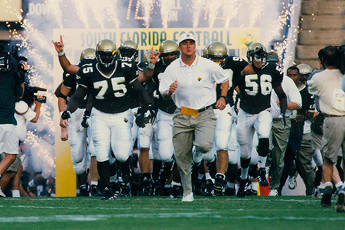 Football team rushes the field in the 1980s
