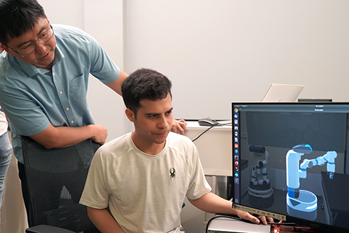 Han with a student in his lab