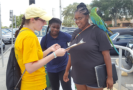 Woman with bird on her shoulder evacuates during Hurricane Ian