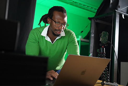 John looking over computer screen in his lab