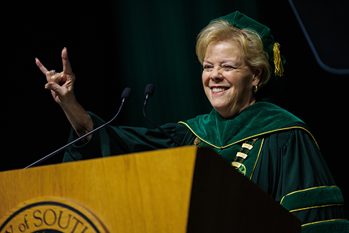 USF President Rhea Law gives the go bulls hand signal at commencement