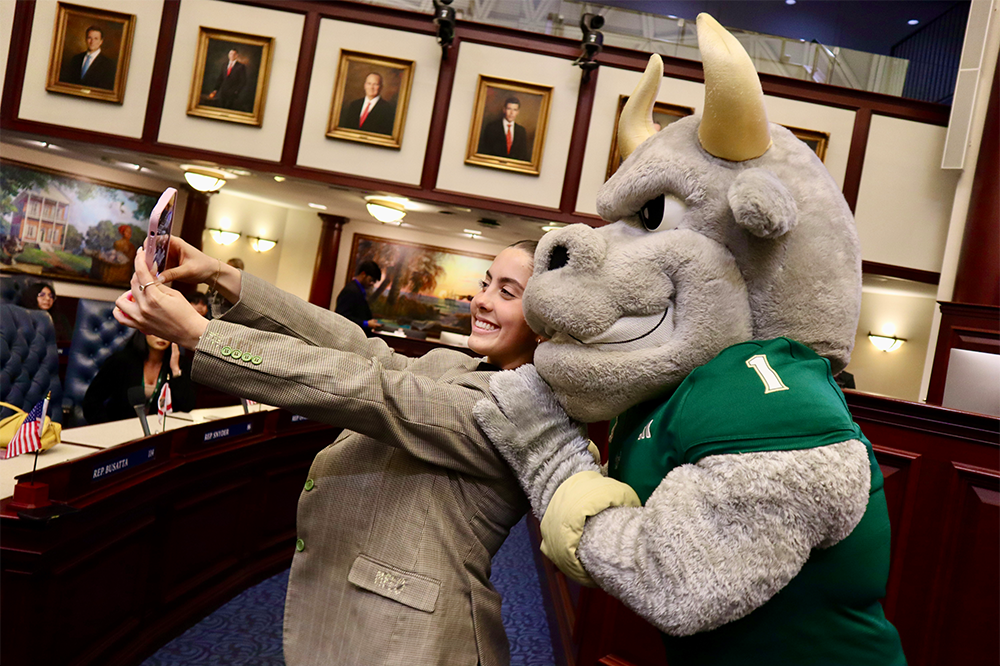 USF student poses with Rocky at the Florida Senate chamber