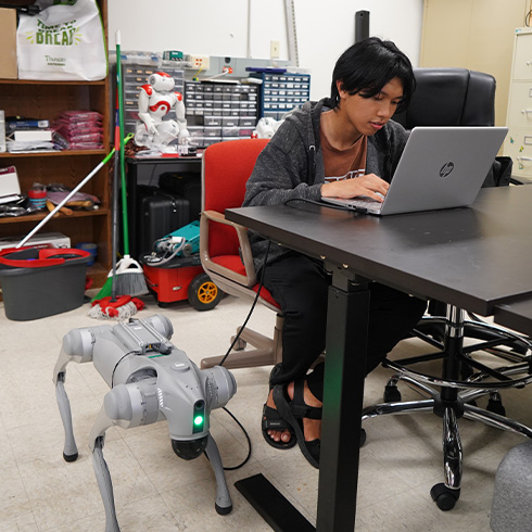 USF student with robot behind him