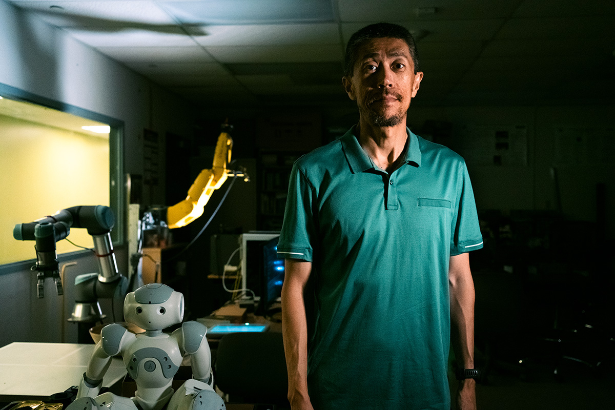 Sun in his lab with robots