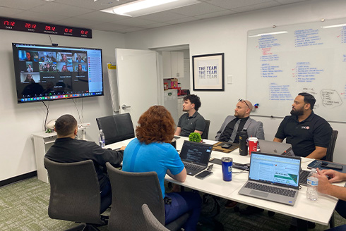 Interns in a meeting with leaders in conference room