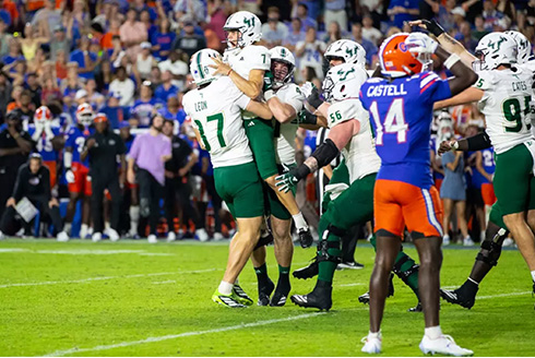 USF football team celebrates on field