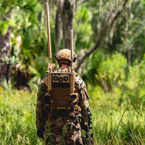 Member of the military walks in forest wearing JCREW
