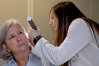 Doctor inspects hearing of patient