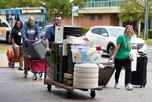 Families carry luggage as students move onto USF's campuses