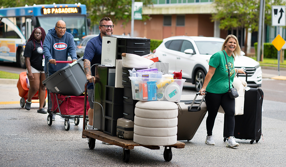 Families carry luggage as students move onto USF's campuses