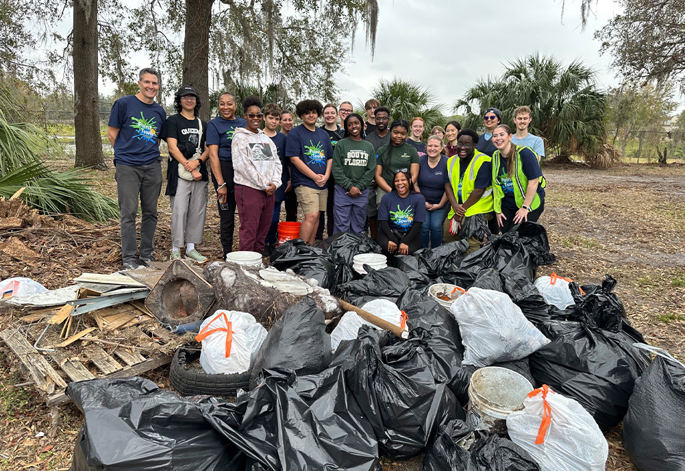 Environmental justice students cleaning up Aaran's Pond with Christian Wells 