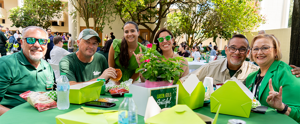 Staff members sit at a table at USF luncheon
