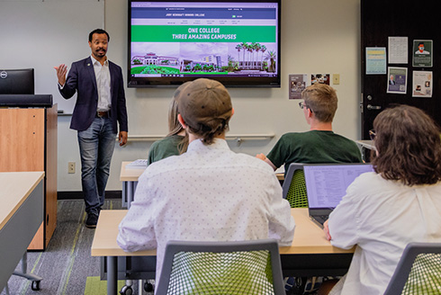 USF faculty member speaks at the front of a classroom