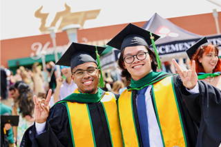 two students outside USF commencement