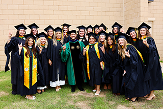 group gathers outside USF commencement