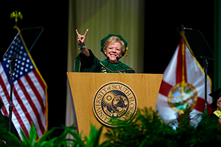 USF President Rhea Law gives the Go Bulls symbol