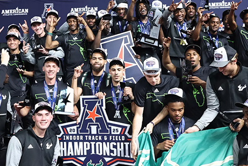 USF Track and Field team poses with AAC championship signage