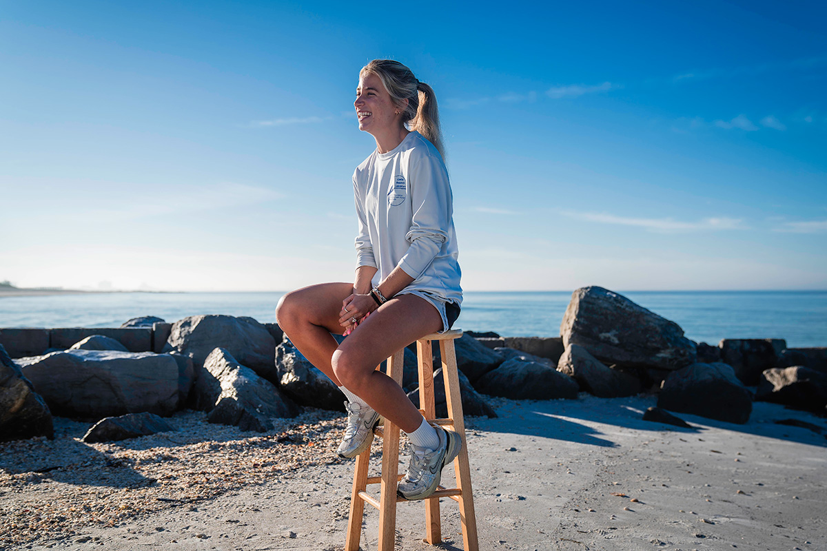 Student sitting on the beach