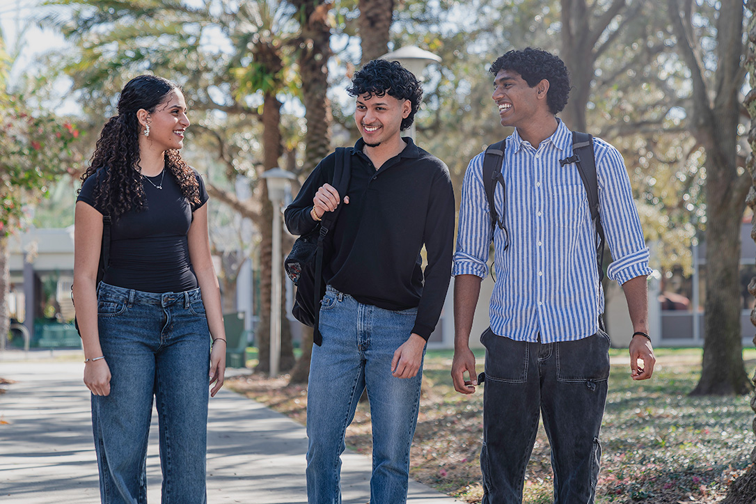 Three students walking toward camera